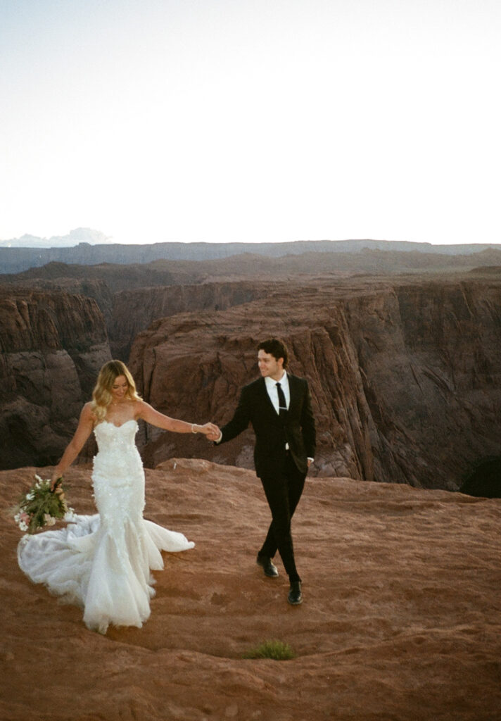 Couple standing in Arizona desert during elopement, captured on 35mm film