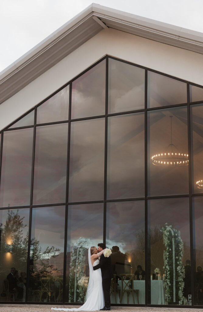 couple standing in front of desert view wedding venue in arizona