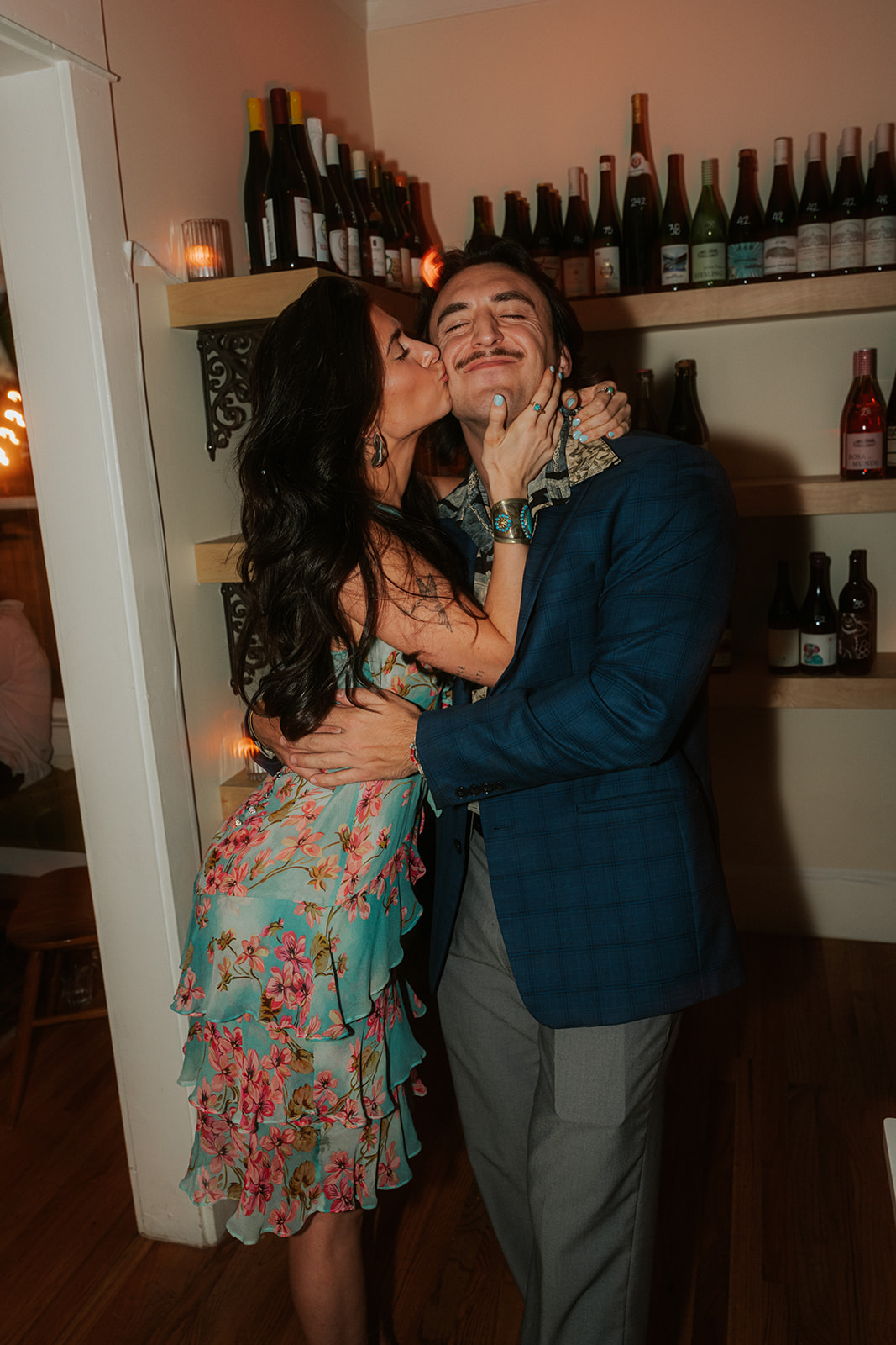 Guest hugging and kissing the groom during a lively Phoenix Courthouse Wedding celebration at a wine bar