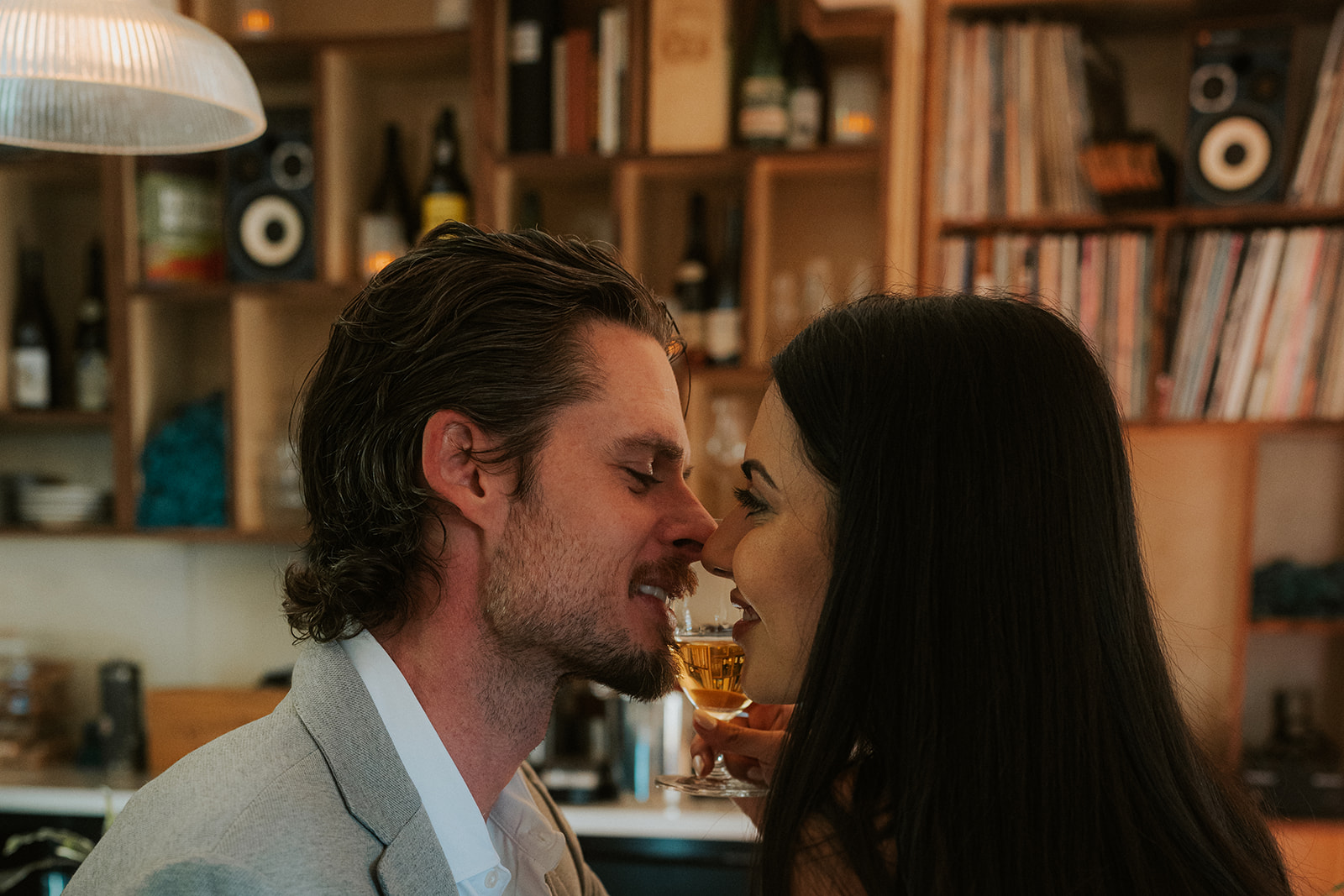 Couple sharing a close, intimate moment with drinks at a cozy bar during their Phoenix Courthouse Wedding celebration