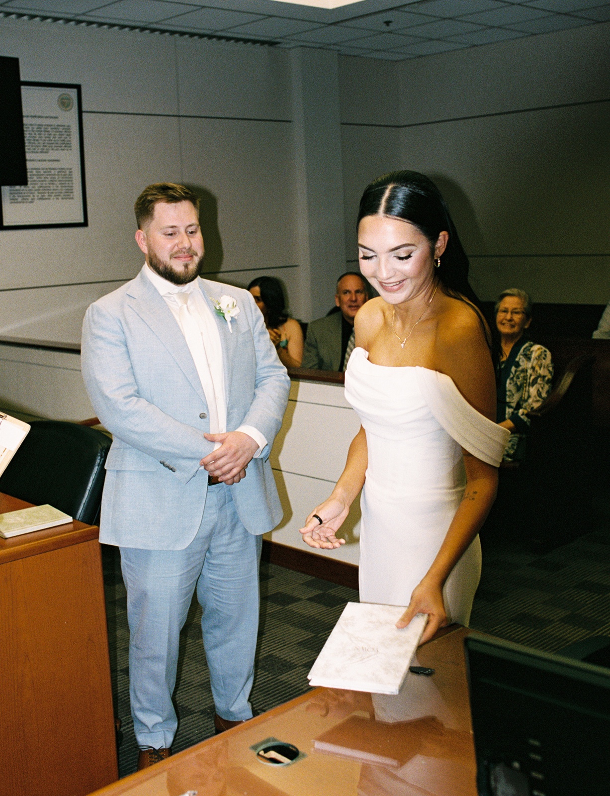 Bride and groom signing paperwork at their Phoenix courthouse wedding