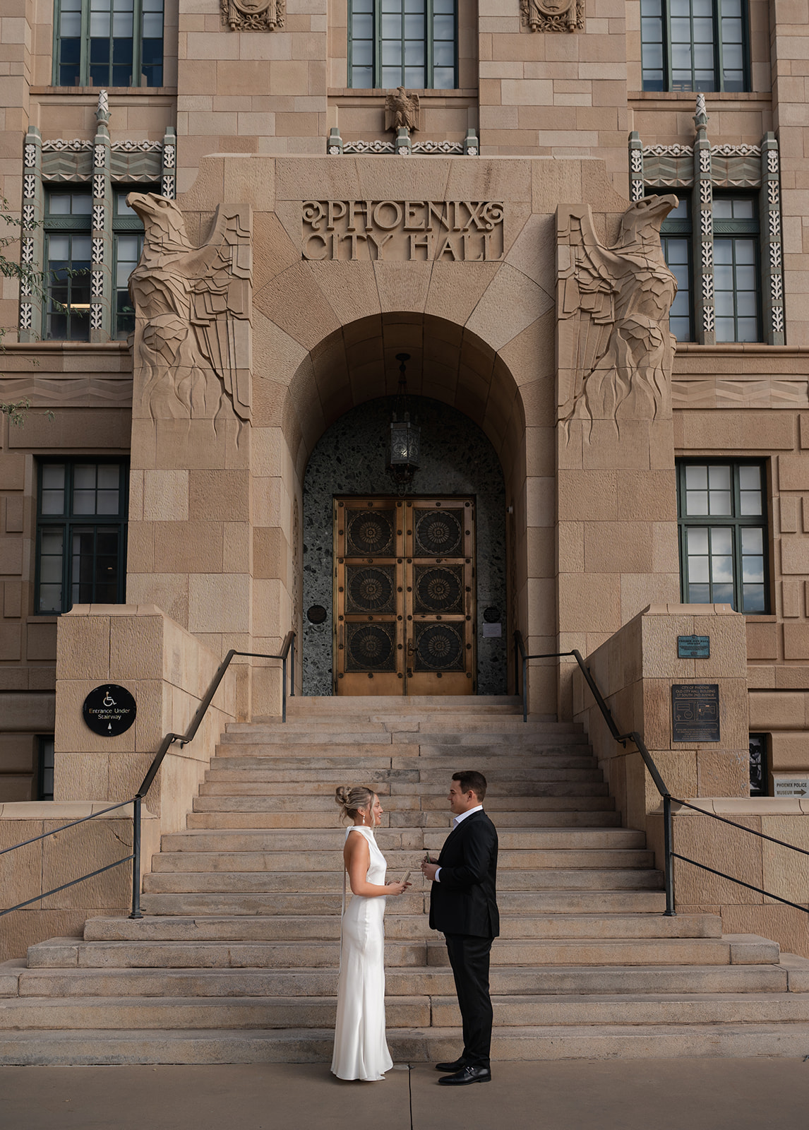 Phoenix courthouse wedding couple standing below courthouse entrance