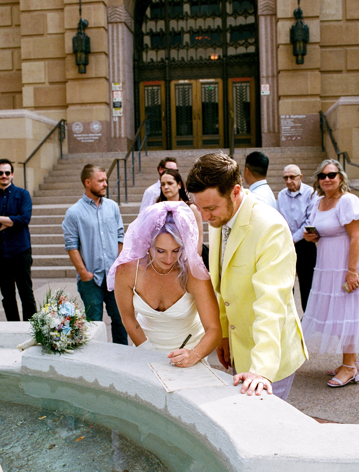 Bride and groom signing their marriage license at their Phoenix Courthouse wedding
