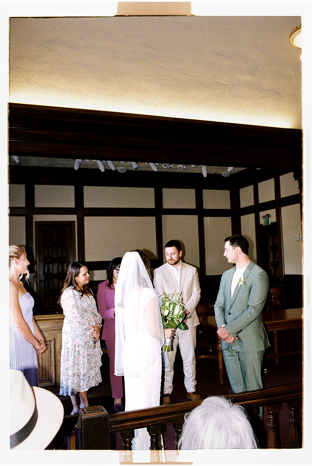 Couple standing together during intimate indoor ceremony