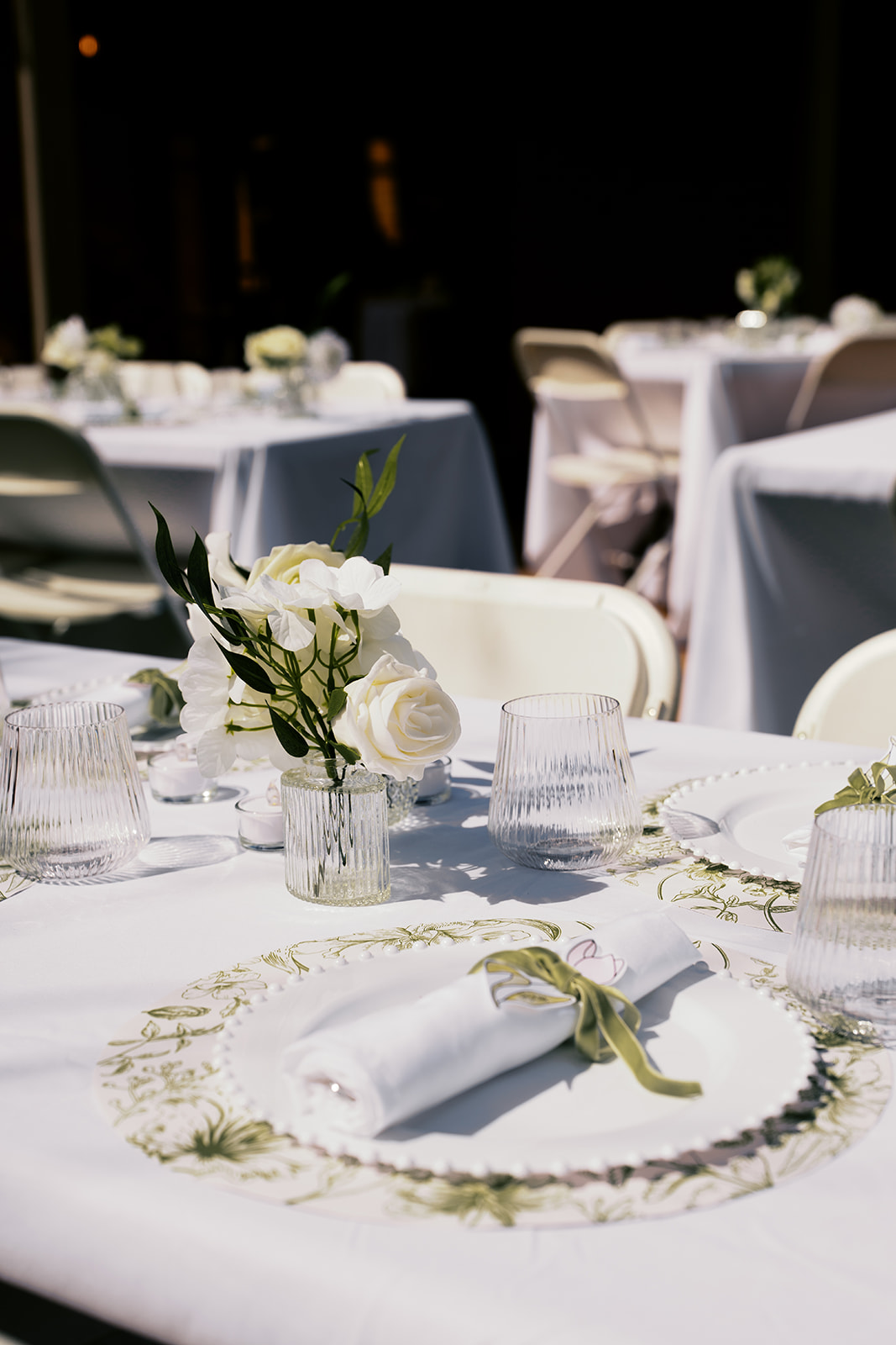 Non-traditional wedding reception table setting with floral details