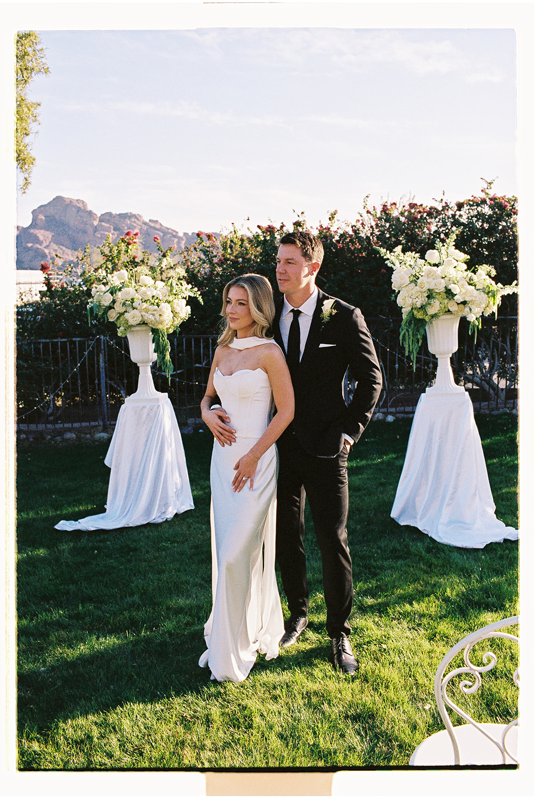 Couple posing with flowers at their non-traditional wedding