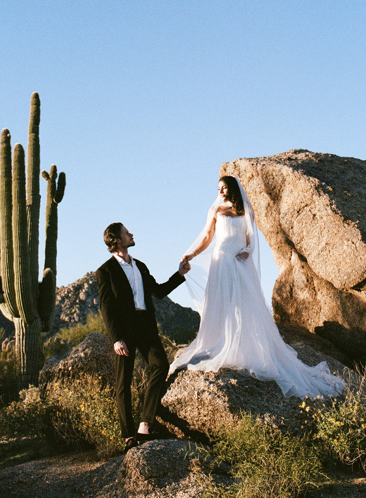Bride and groom on rocks in the Arizona desert