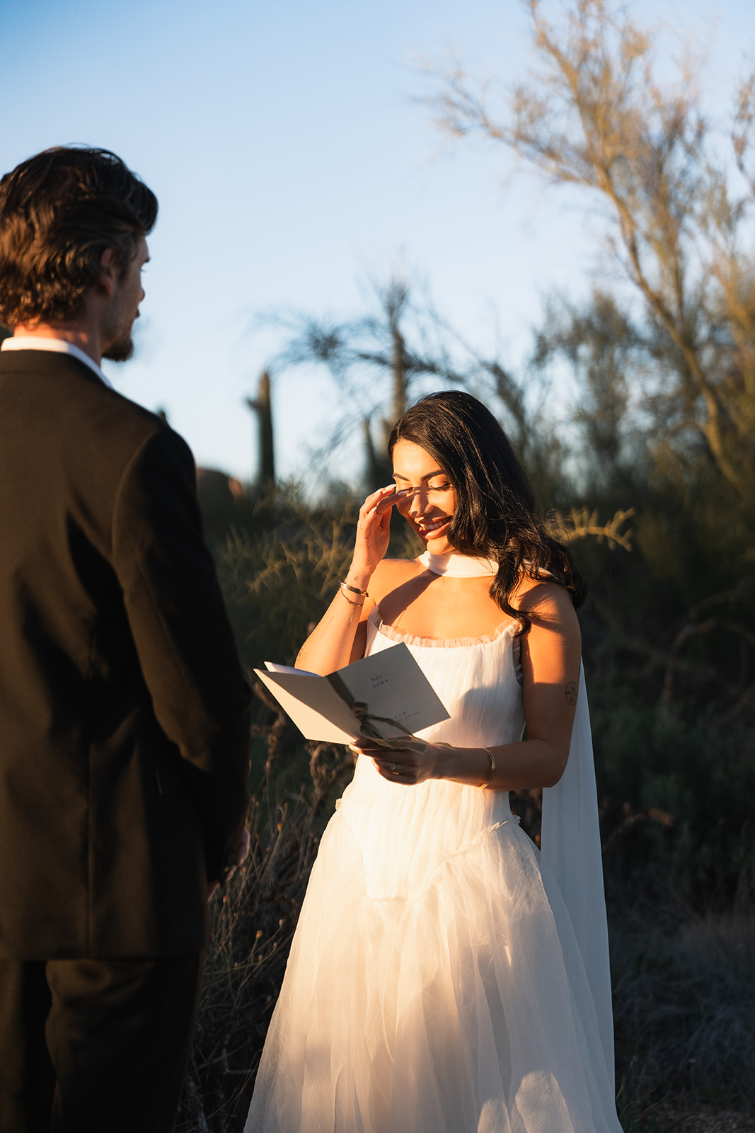 Couple exchanging vows at sunset on film