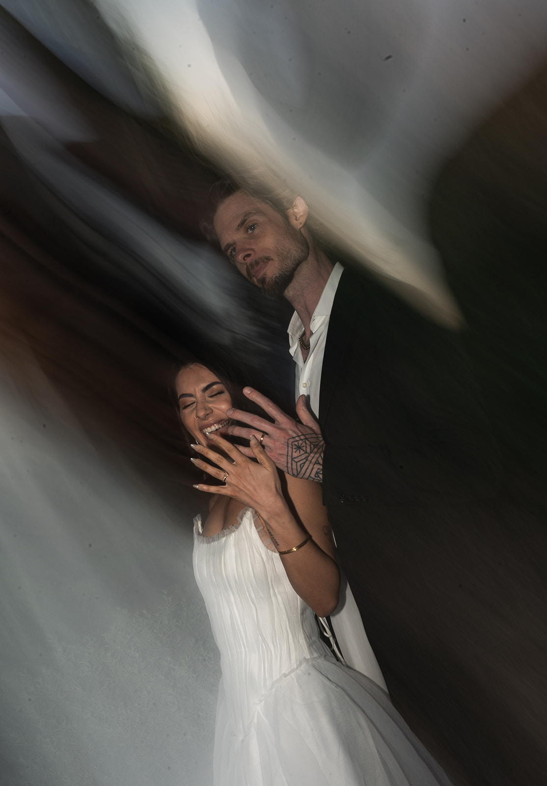 Bride and groom hold up wedding bands after their non-traditional wedding