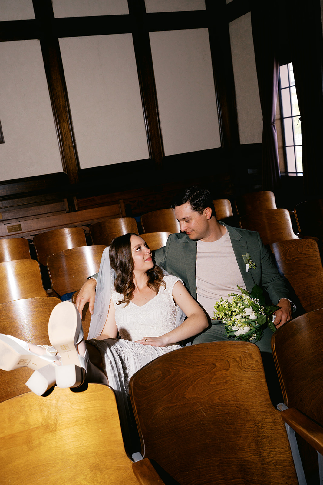 Couple relaxing in courthouse seats after their non-traditional wedding