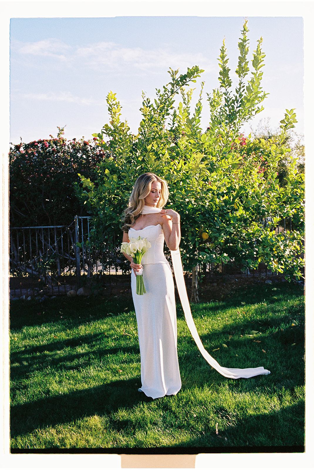 Bride holding bouquet outside after a non-traditional wedding