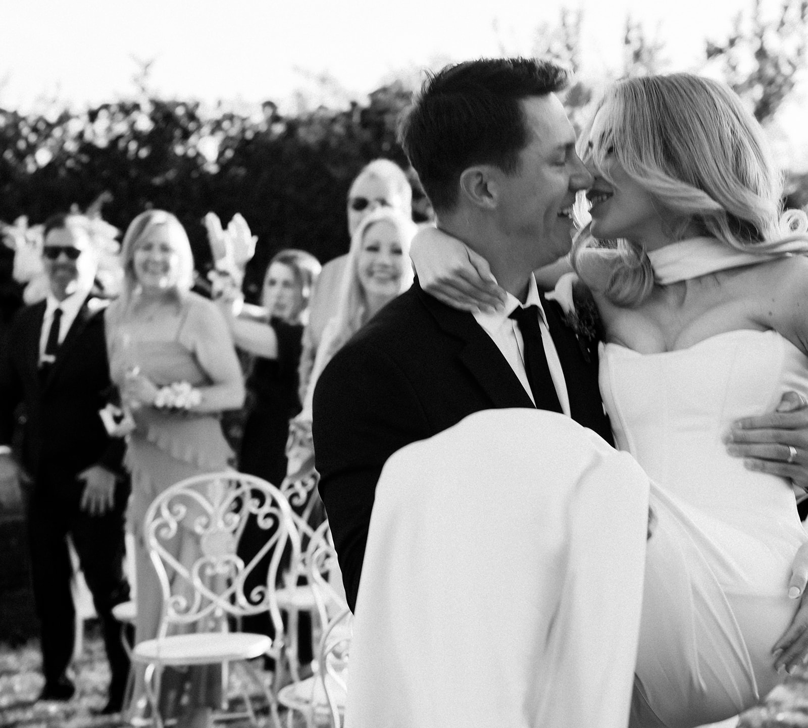 Couple kissing as guests cheer at their non-traditional wedding