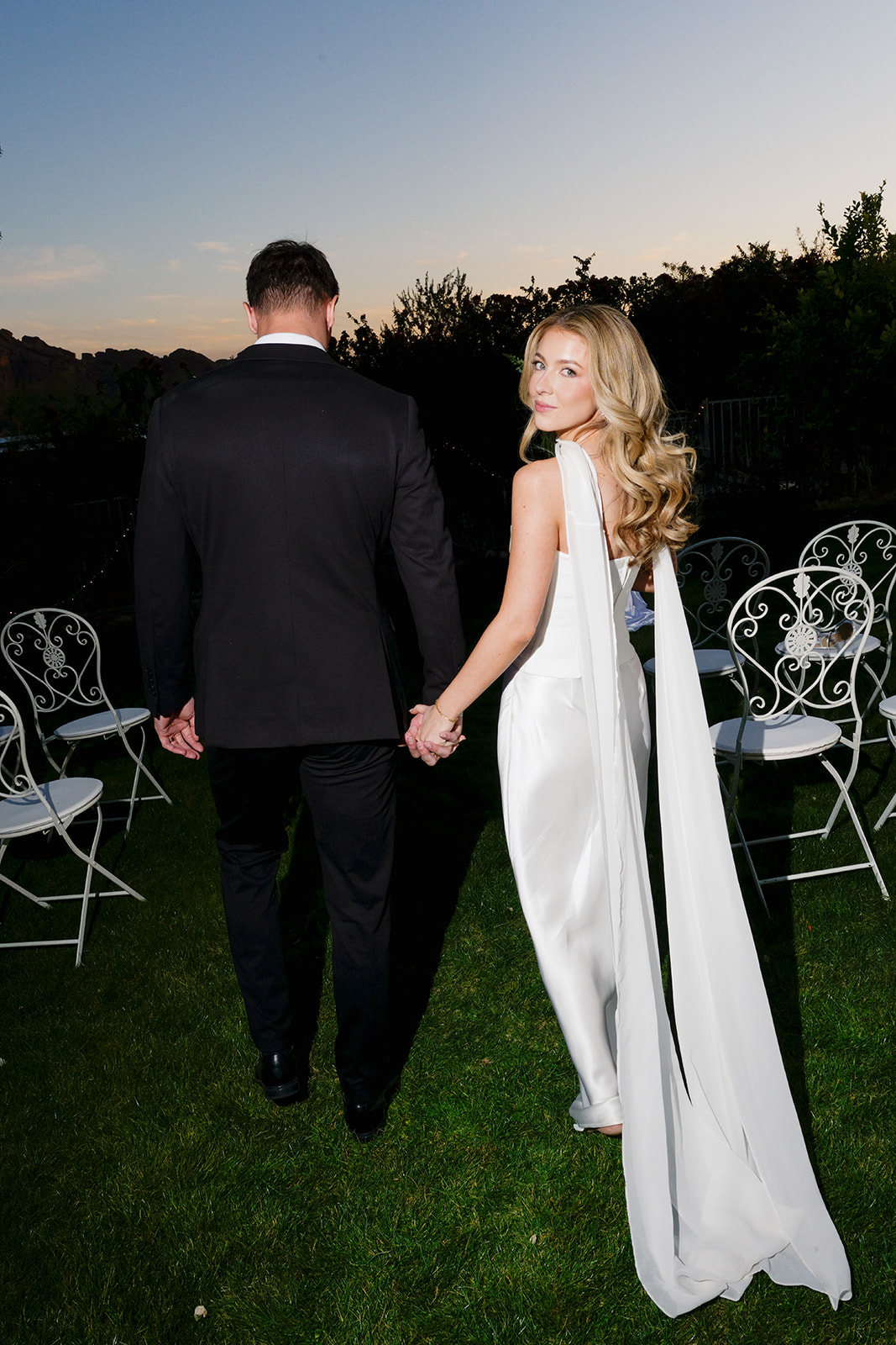 Couple walking hand in hand after their non-traditional wedding