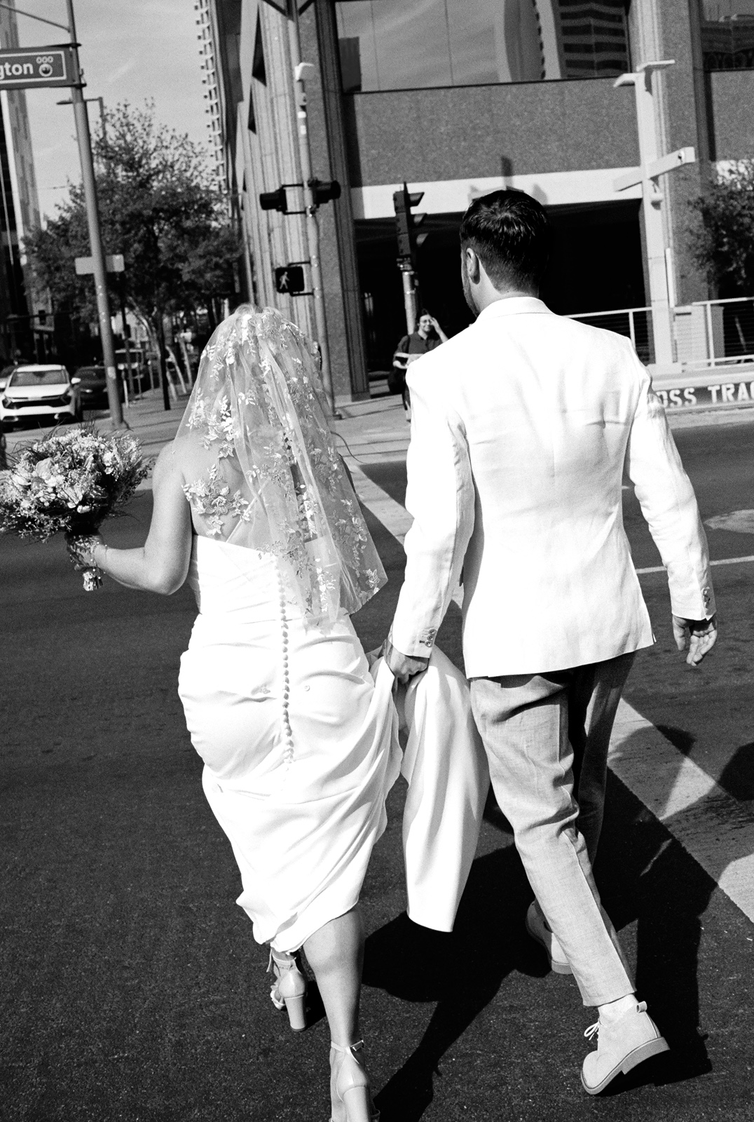 Newlyweds walking away together in downtown Phoenix
