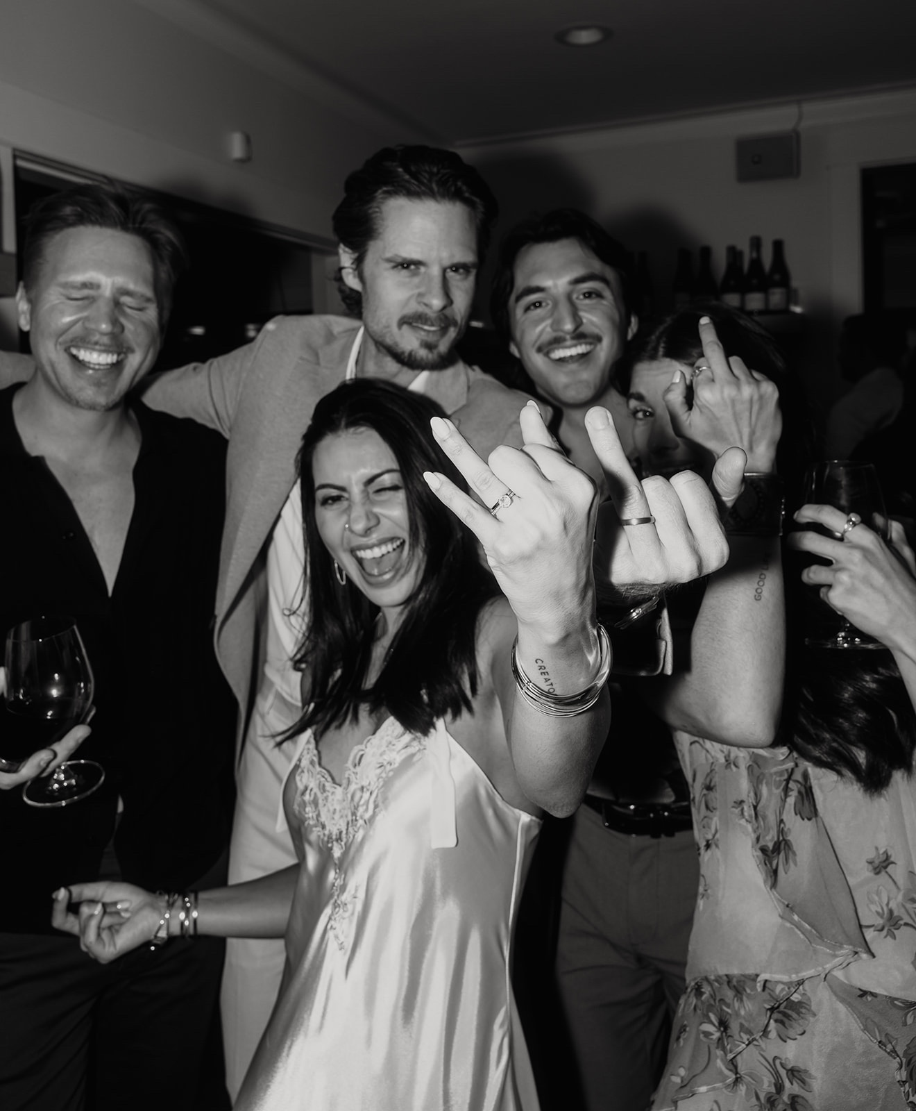 Friends celebrating and laughing at wine bar together