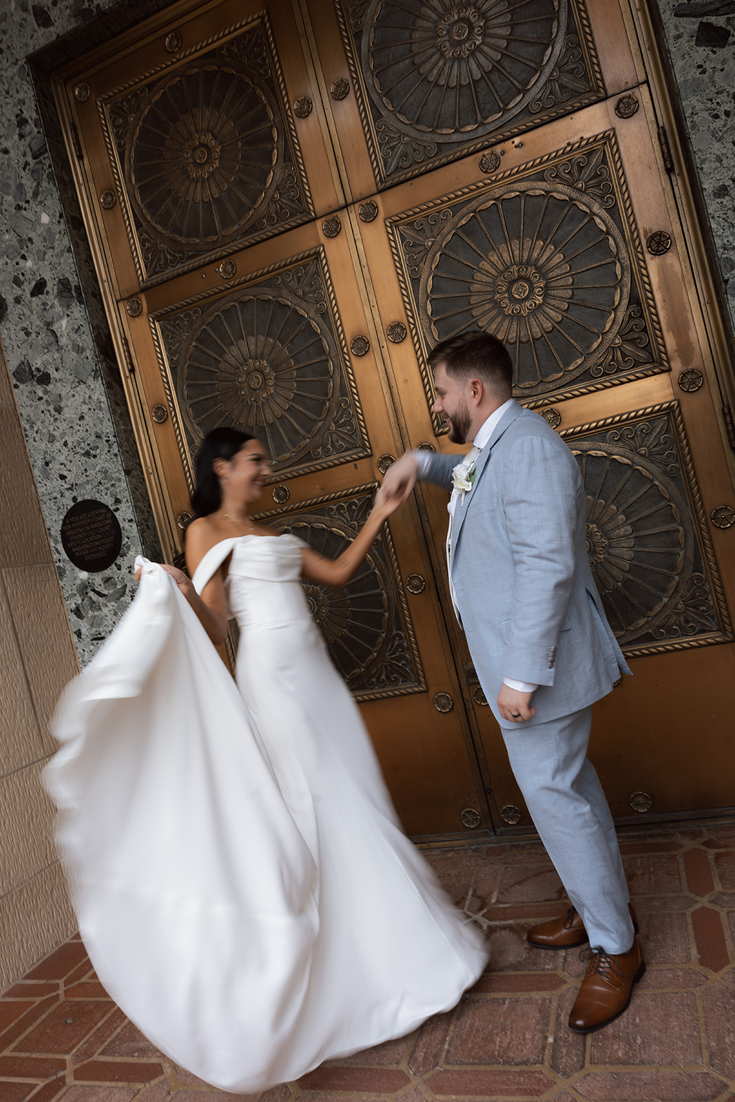 Phoenix courthouse wedding couple holding hands by ornate doors