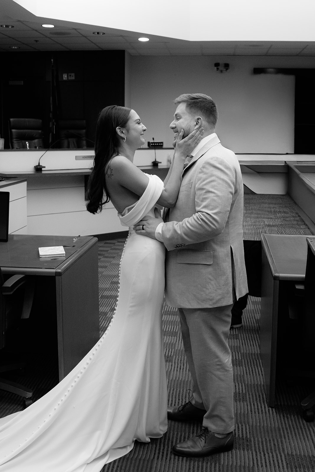 Phoenix courthouse wedding couple embracing during indoor ceremony