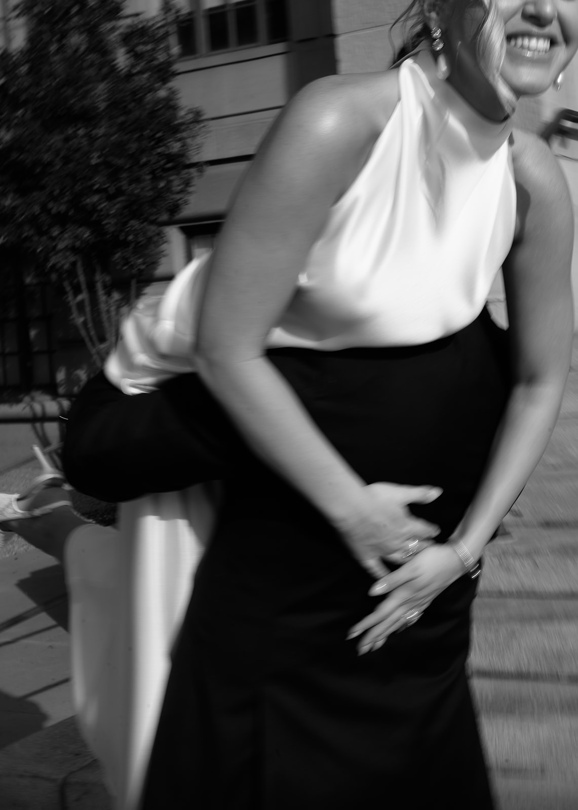 Close-up of bride getting picked up by groom