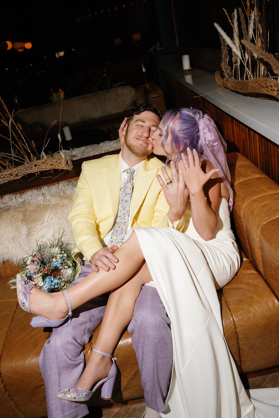 Couple sitting closely on couch, smiling together