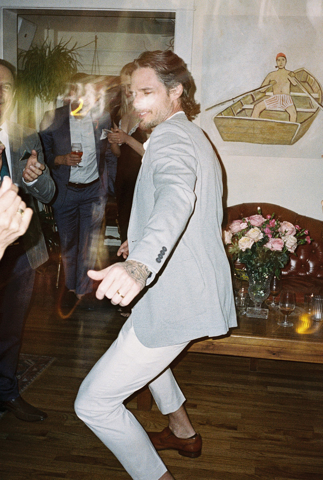 Man dancing energetically at wedding celebration indoors