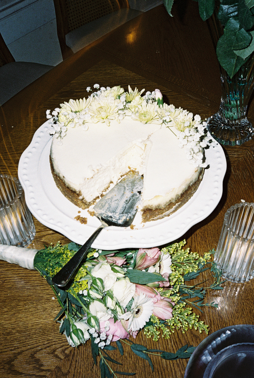 Wedding cake with slice removed on table