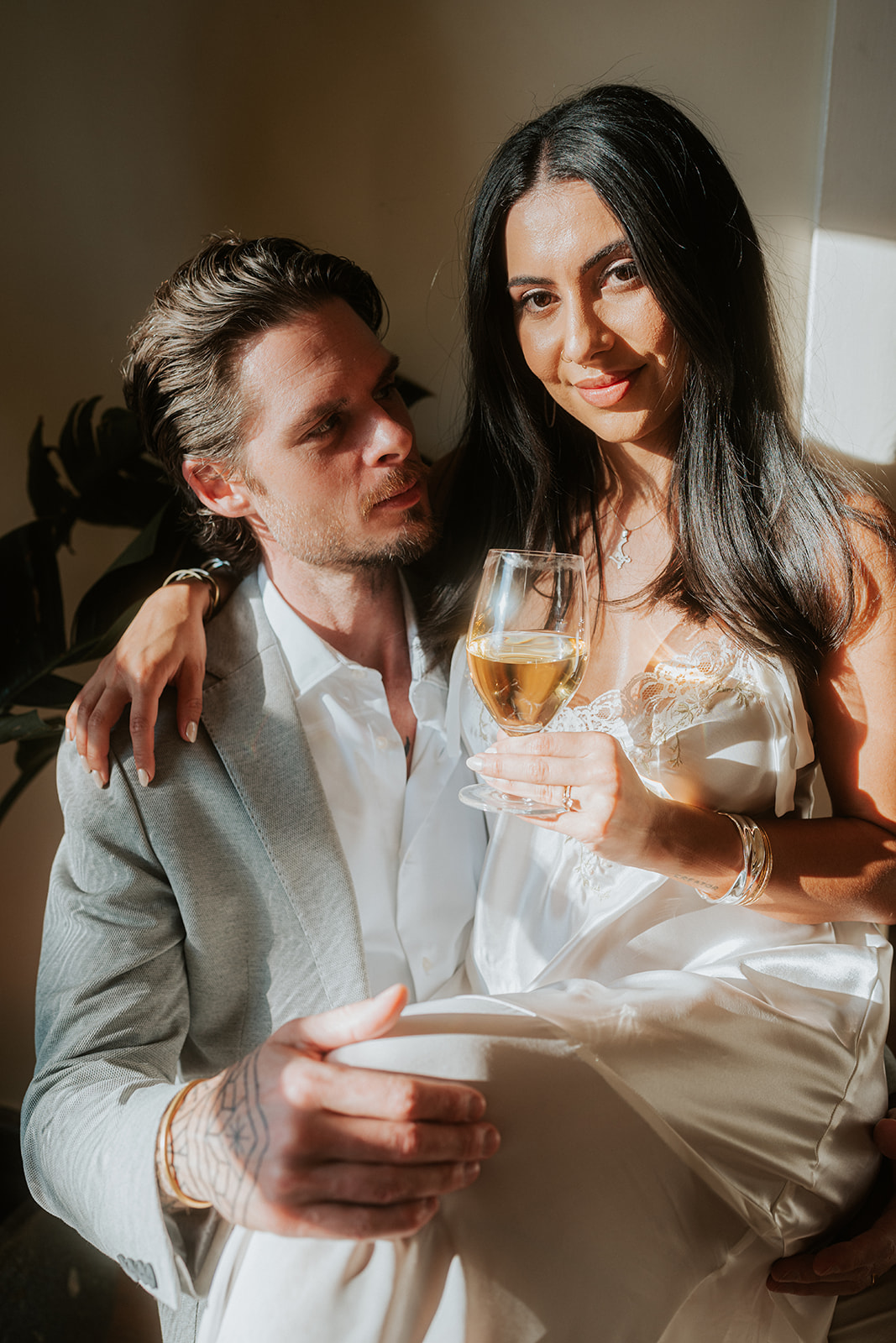 Couple relaxing together, holding drinks and smiling
