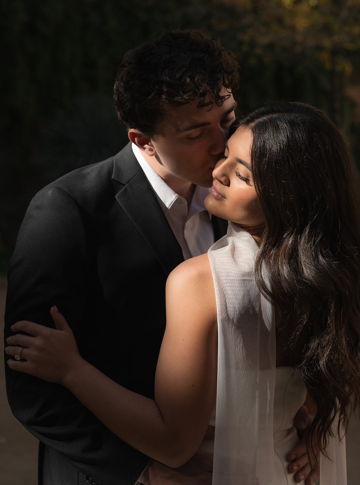 Romantic close-up of bride and groom embracing with soft golden light at one of the most intimate wedding venues in Phoenix Arizona— The Abbey at Monroe