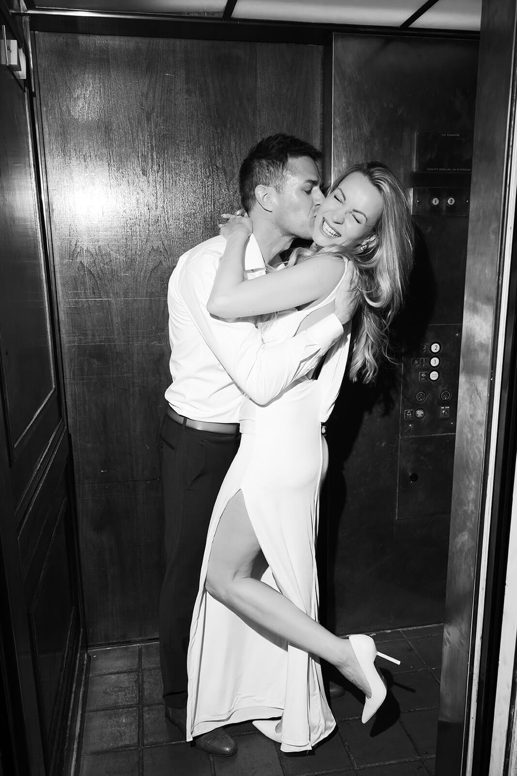 Black and white photo of couple embracing in elevator at Wrigley Mansion wedding venue in Phoenix Arizona