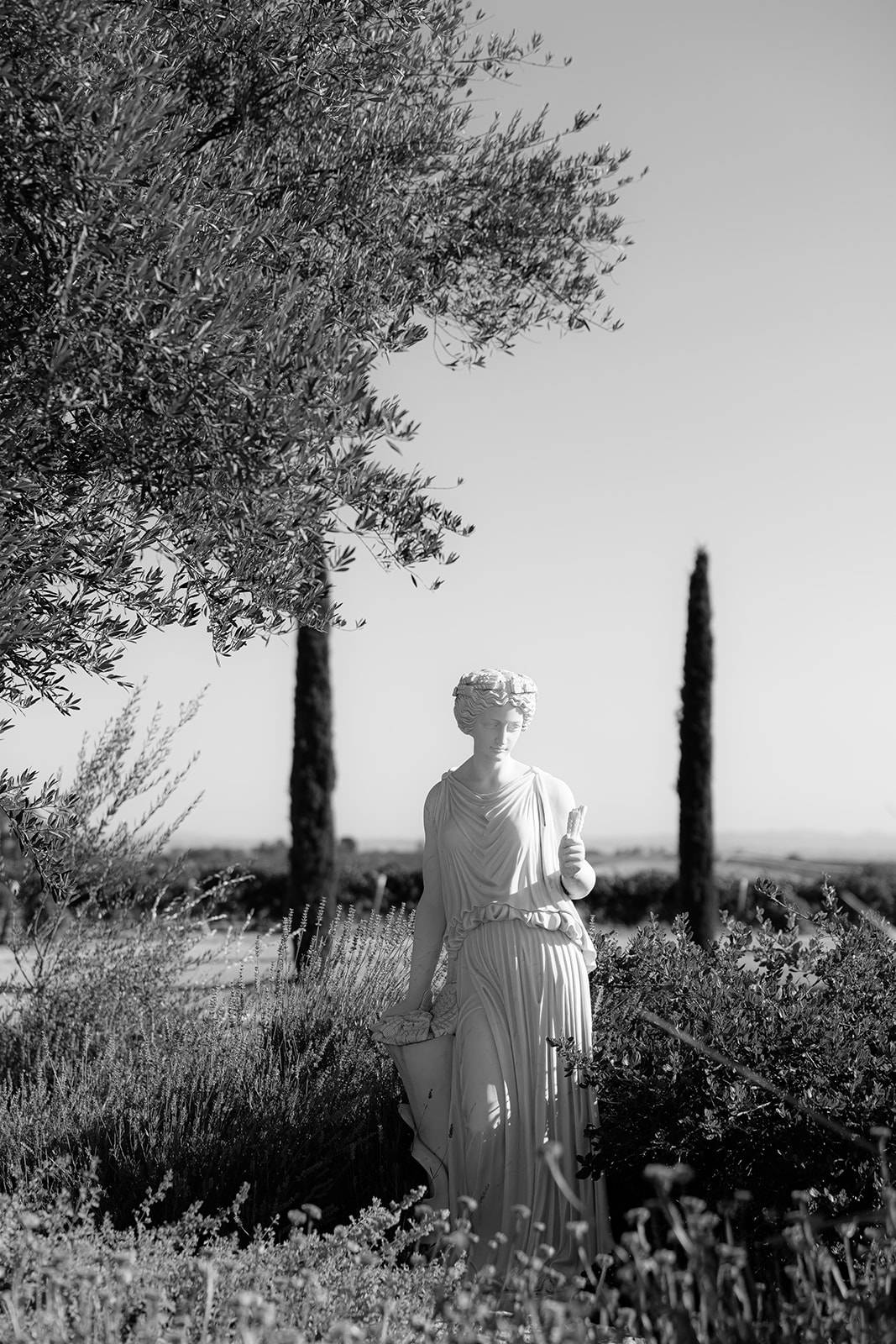 Classical garden statue surrounded by greenery at Villa San Juliette, a romantic San Luis Obispo wedding venue with vineyard landscape in the background