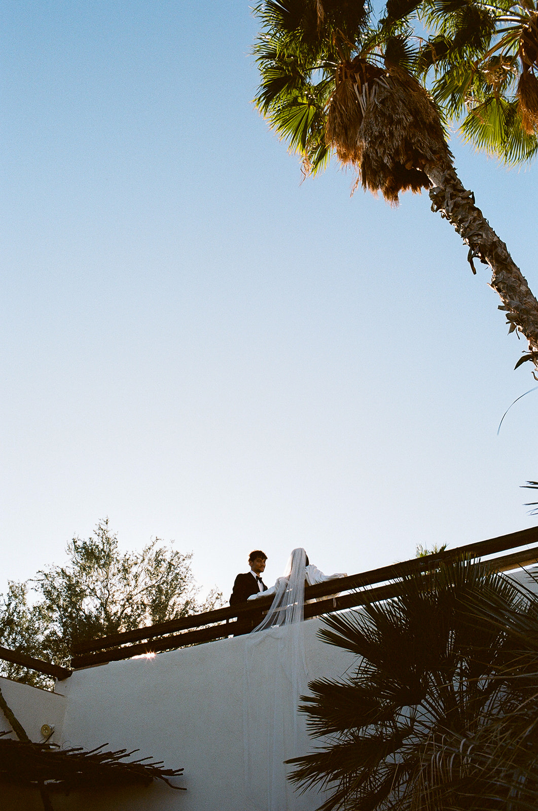 Couple stands on bridge at Joshua Tree House Tucson wedding