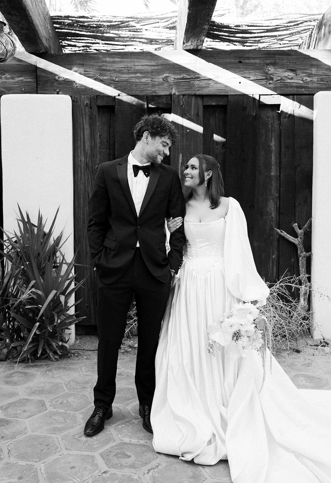 Black-and-white photo of couple walking together and smiling