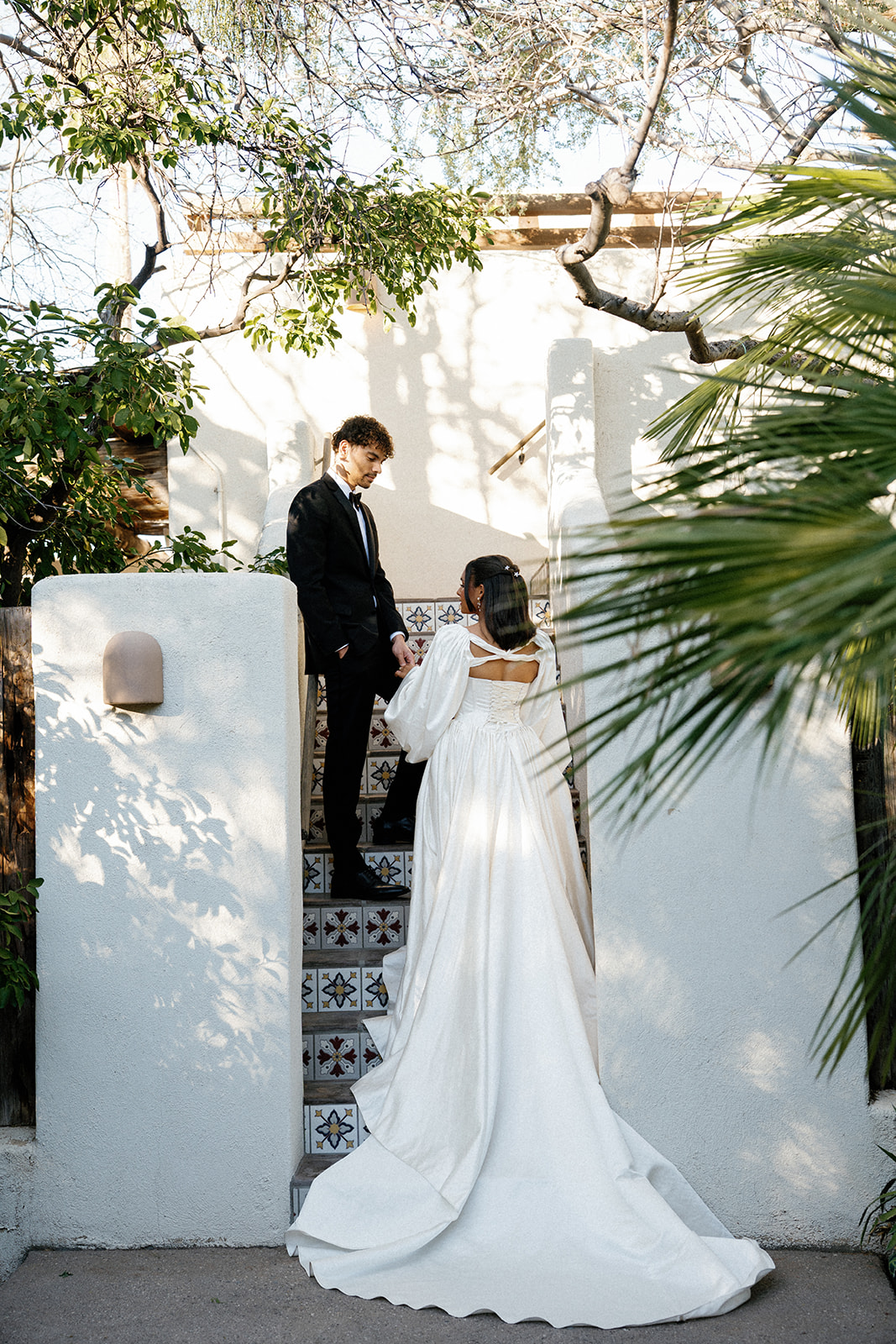 Couple meets on staircase at their Joshua Tree House Tucson wedding