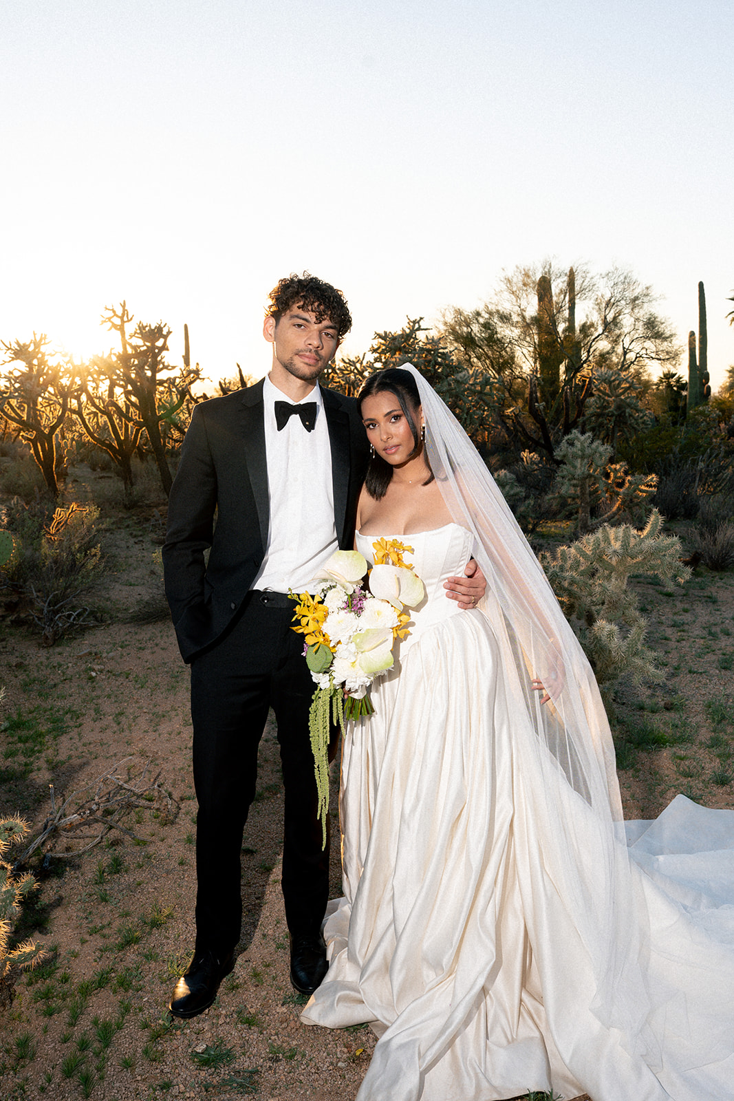 Bride and groom embrace at sunset in Joshua Tree House Tucson wedding