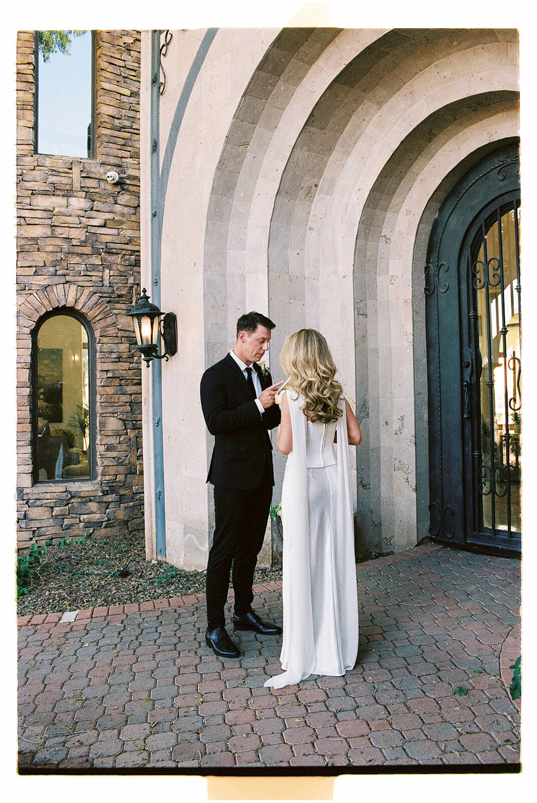 Bride and groom sharing a quiet moment outside a European-inspired venue before their intimate micro wedding ceremony