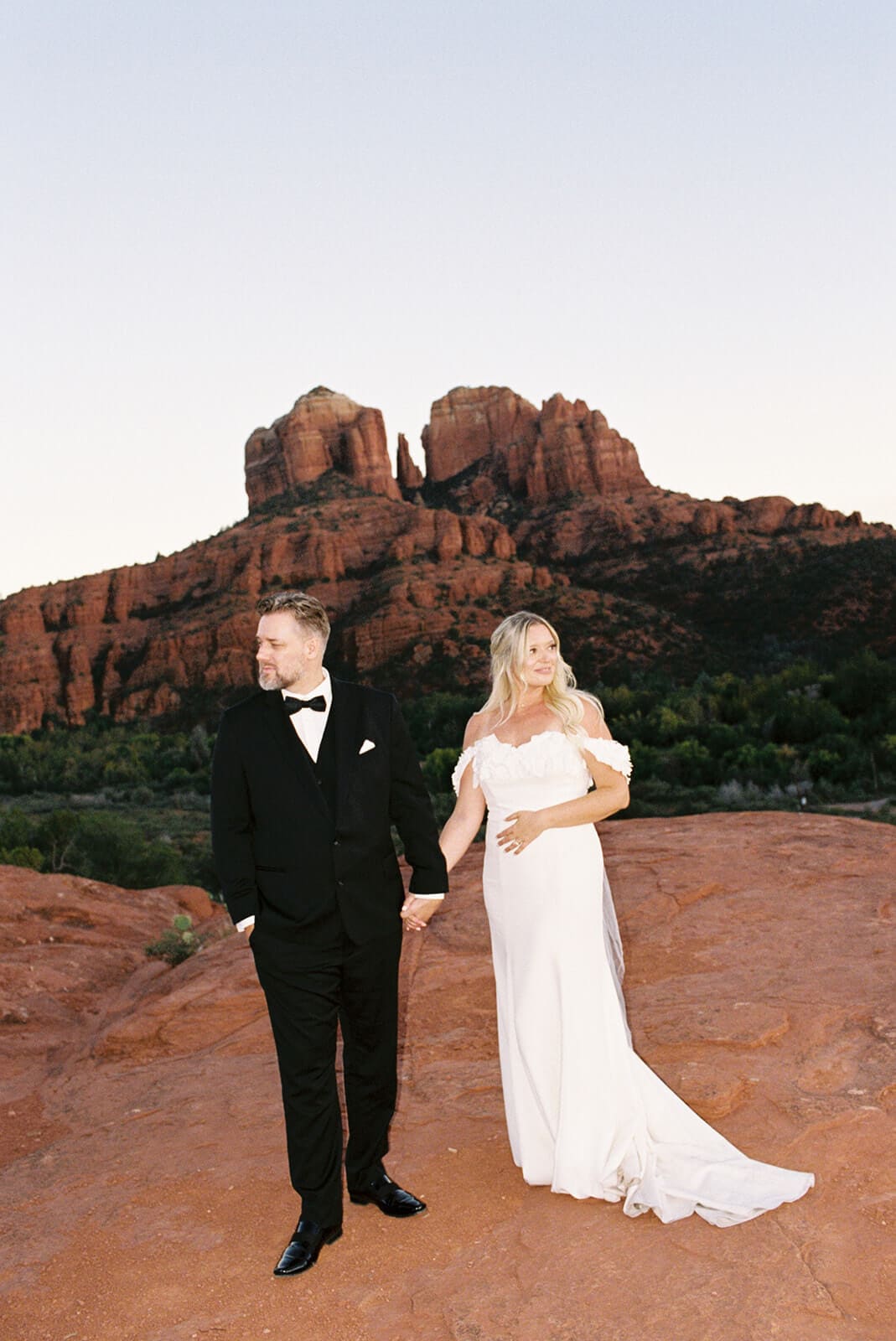 Bride and groom walking together after their desert micro wedding ceremony in Sedona