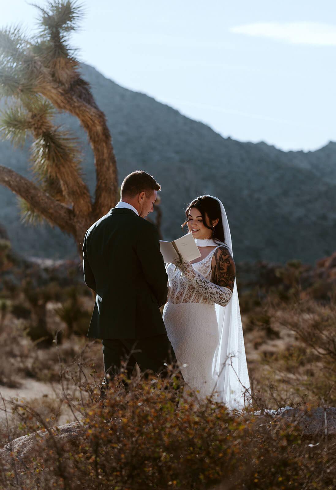 Couple reading private vows during an intimate desert elopement ceremony in Joshua Tree