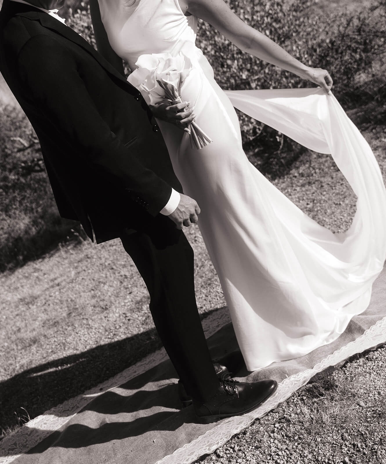 Artistic detail photo of bride holding her veil and bouquet during a modern micro wedding