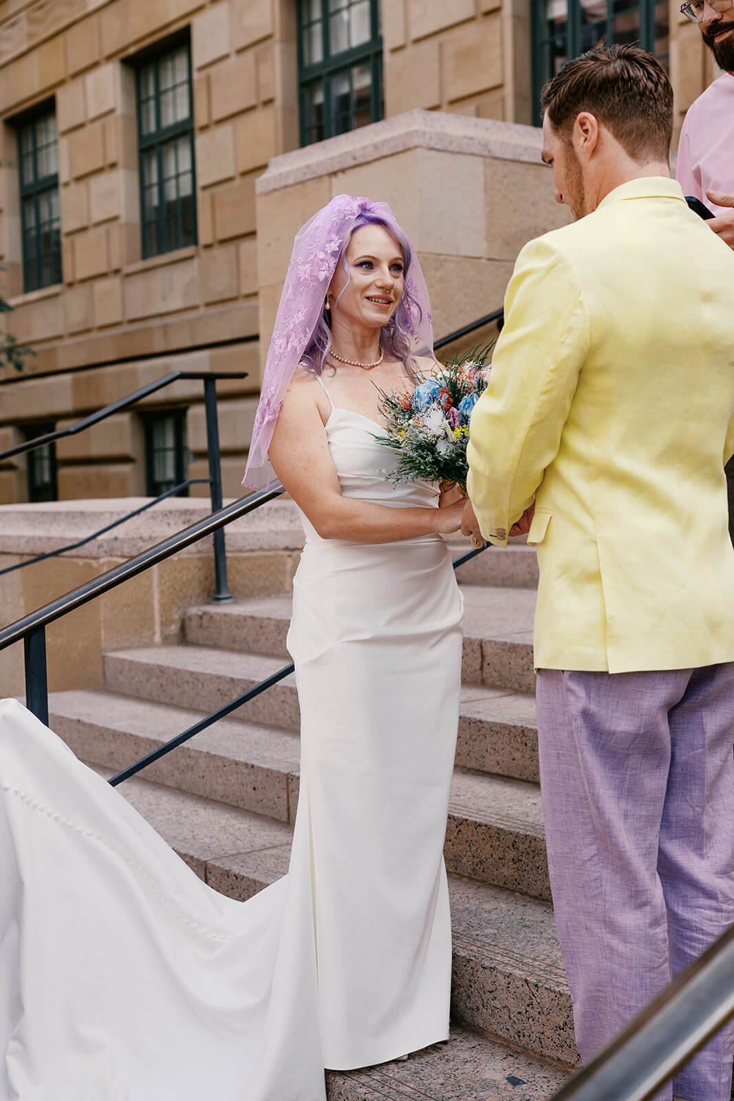 Bride and groom holding hands during their intimate courthouse micro wedding ceremony in downtown Phoenix
