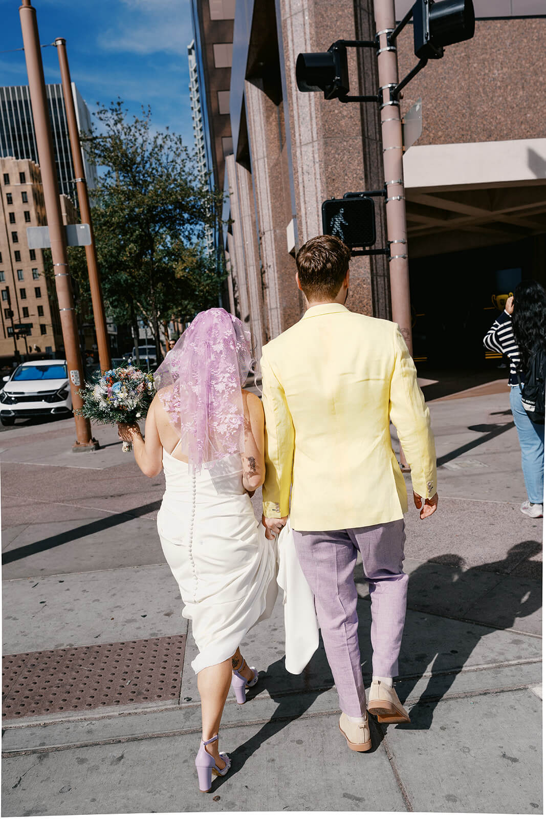 Couple walking through downtown together after their courthouse micro wedding ceremony
