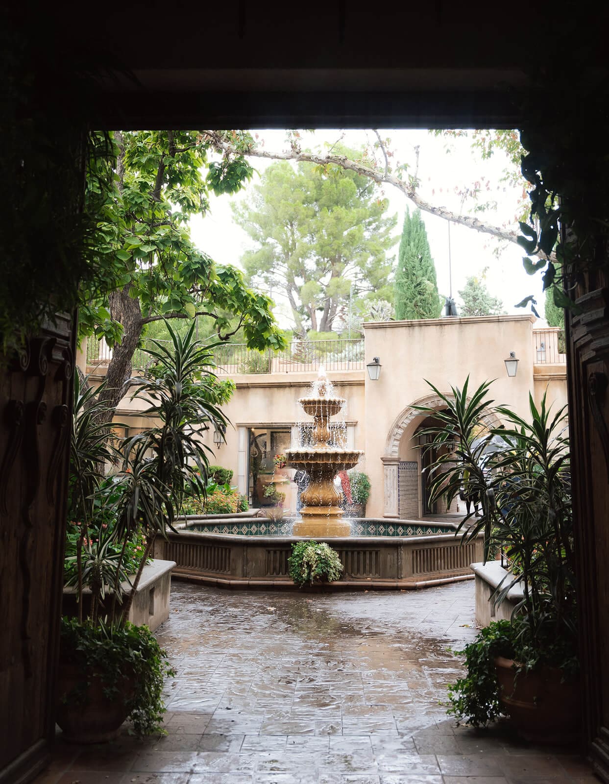Courtyard fountain surrounded by tropical plants and Spanish-style architecture at Tlaquepaque.