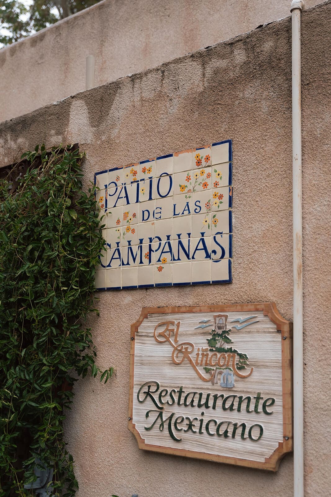 Stucco wall with decorative tile signage reading “Patio de las Campanas” at Tlaquepaque.