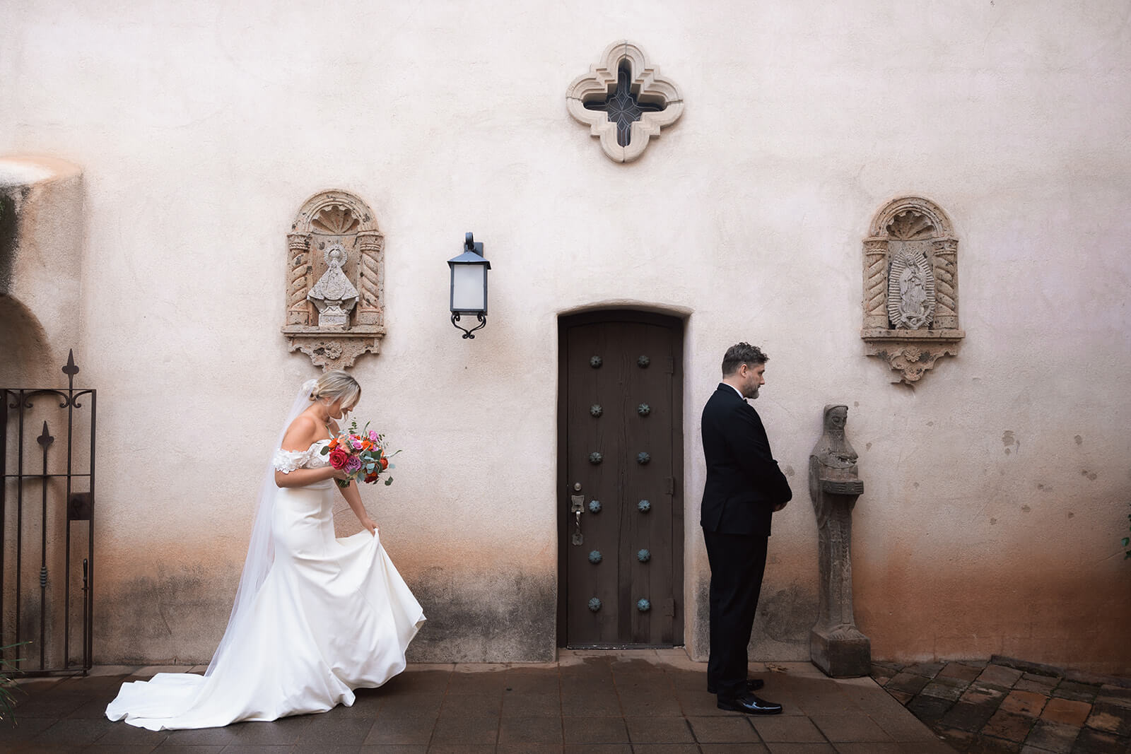 Bride walking toward groom for their private first look during an intimate chapel elopement