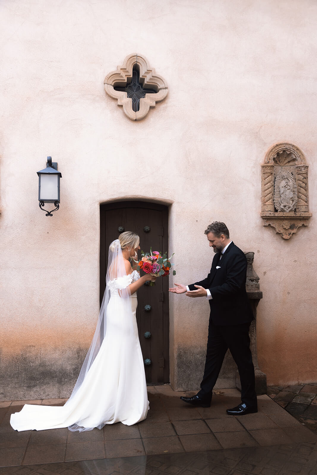 Emotional first look moment between bride and groom during a luxury micro wedding at a historic venue