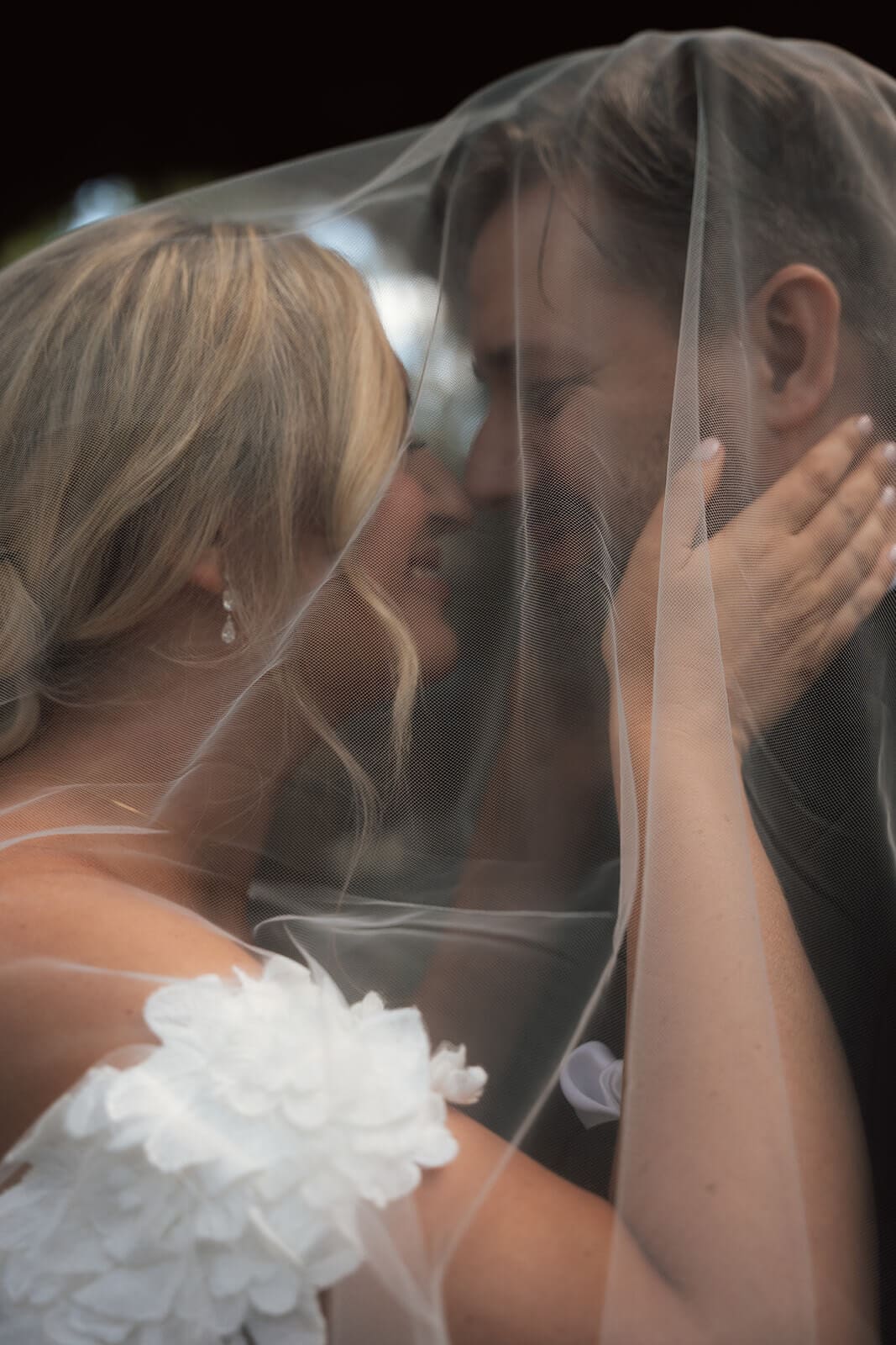 Close-up portrait of the bride and groom embracing beneath the bride’s veil during a micro wedding at Tlaquepaque.