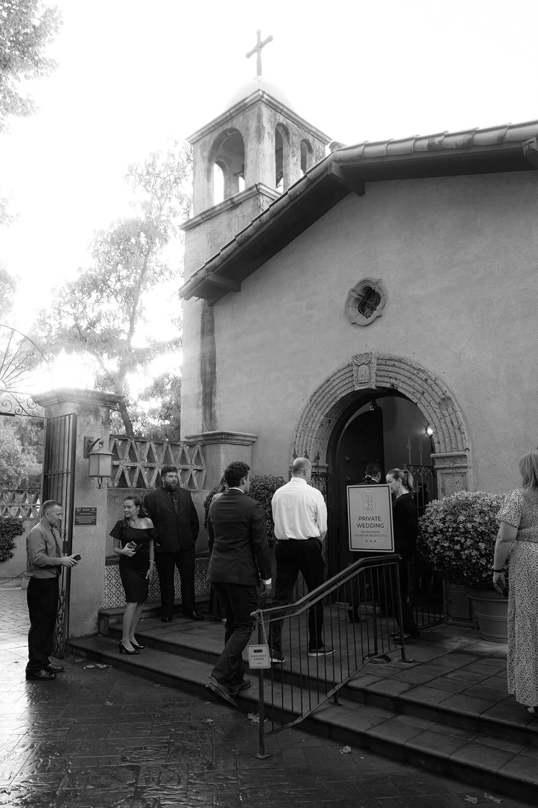 Guests arriving outside a historic chapel for a private micro wedding ceremony in an intimate setting
