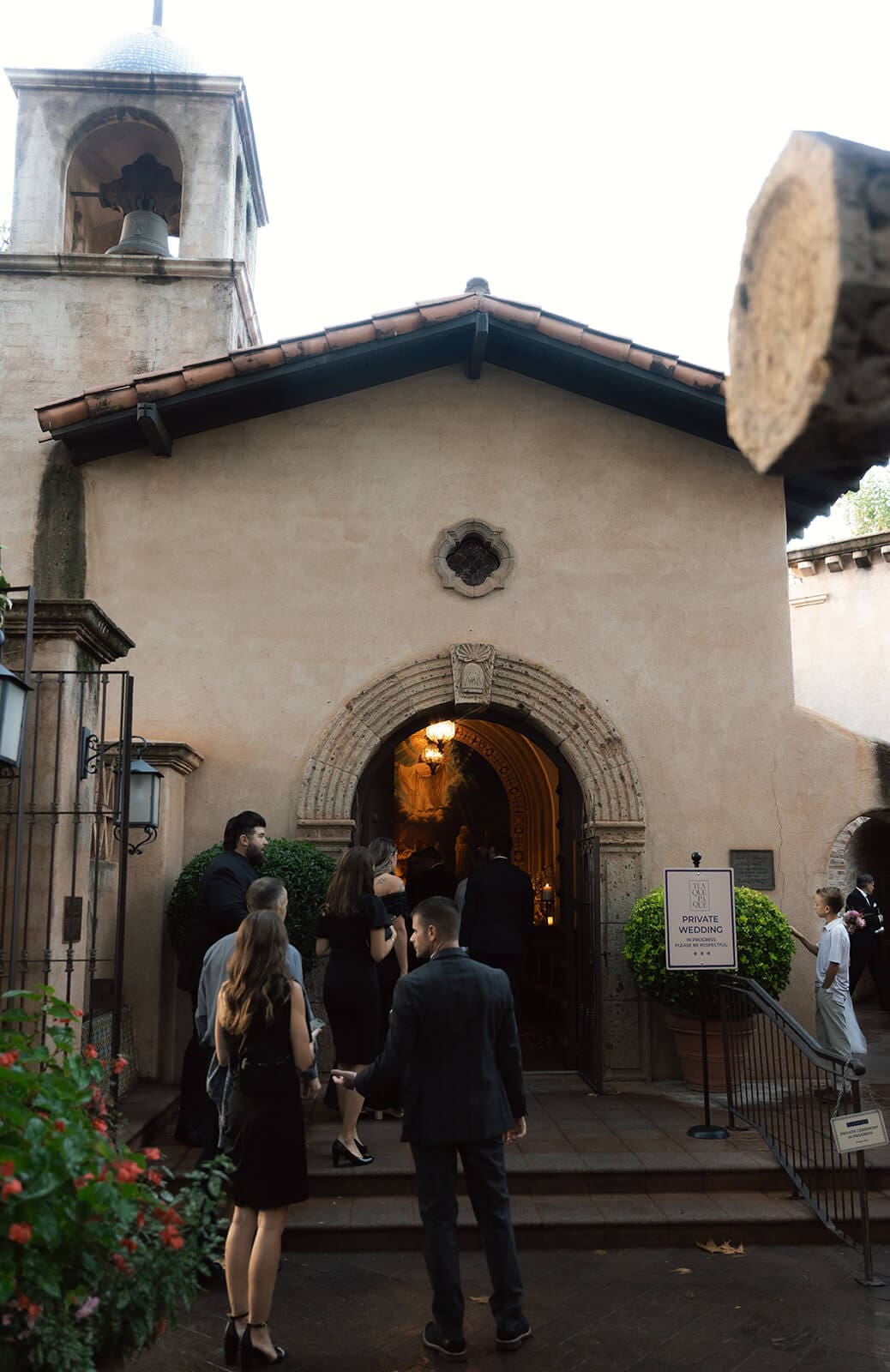 Guests arriving outside a Spanish-style chapel before a micro wedding ceremony at Tlaquepaque.