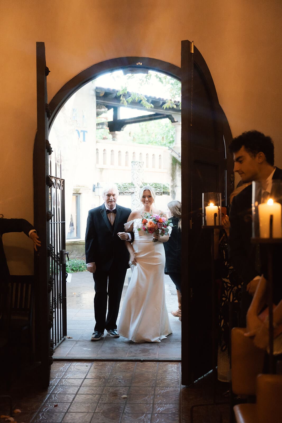 Bride walking down the aisle with her father during a romantic chapel micro wedding ceremony