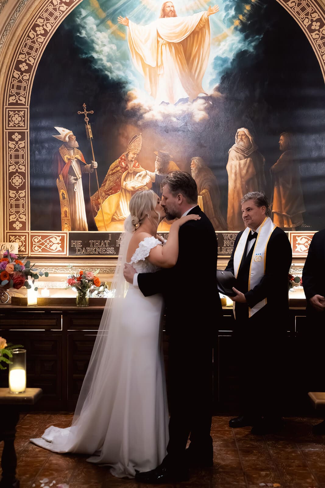 Bride and groom embracing at the altar inside the chapel during their wedding ceremony at Tlaquepaque.