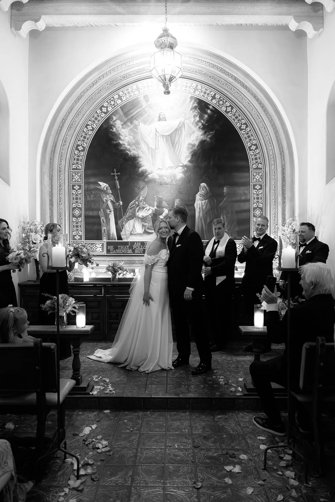Black and white photo of a bride walking down the aisle with her father inside a chapel during a micro wedding at Tlaquepaque.