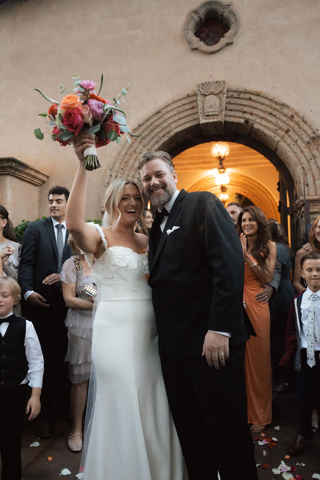 Bride and groom celebrating outside the chapel entrance after their ceremony during a micro wedding at Tlaquepaque.